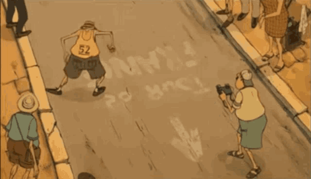 a group of people are riding bicycles down a street with the word olympic written on the sidewalk