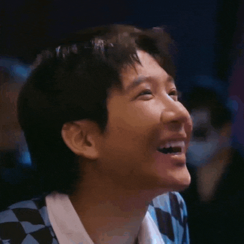 a close up of a person 's face with a laughing expression