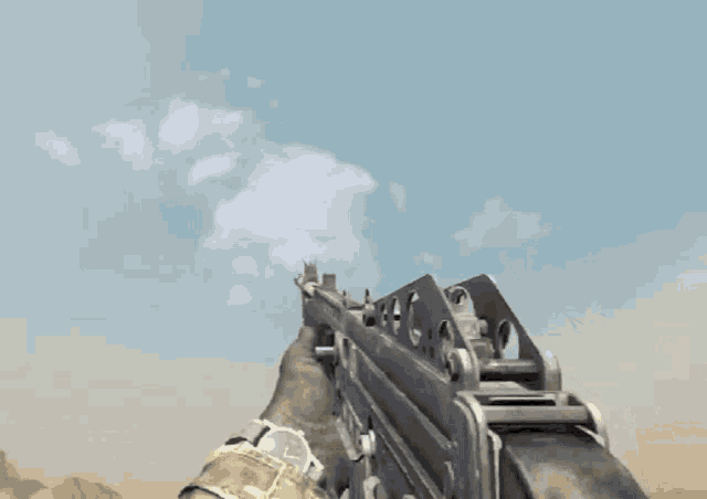 a man in a camouflage shirt is holding a gun with the number 00 on it