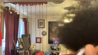 a blurry picture of a living room with a red curtain