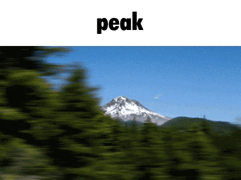 a blurry picture of a mountain and the word peak