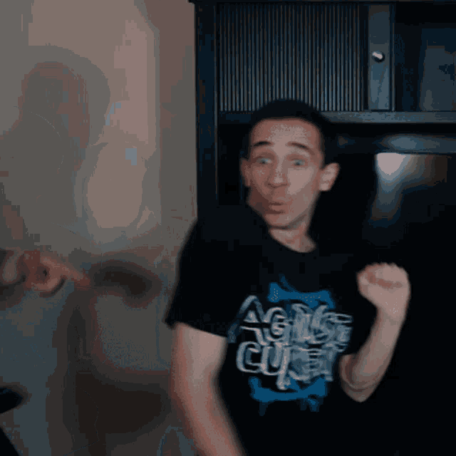 a man wearing a black shirt that says agile cube