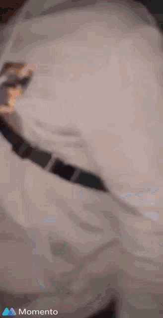 a man is wearing a white shirt and a black belt