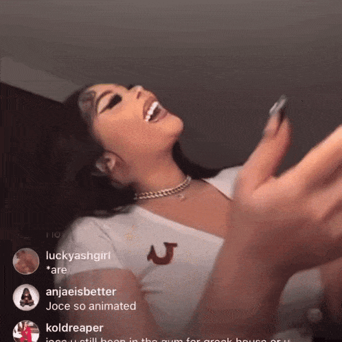 a woman in a white top with a red u on it