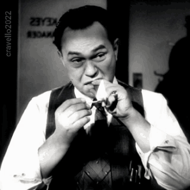 a man smoking a cigarette in front of a sign that says cravello20202