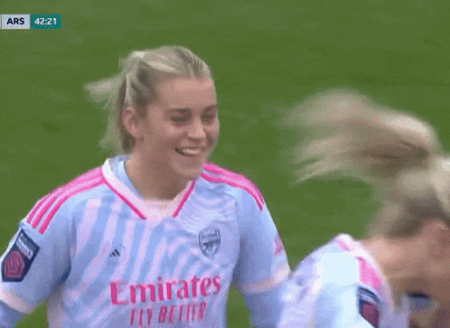 a female soccer player wearing an emirates fly better shirt