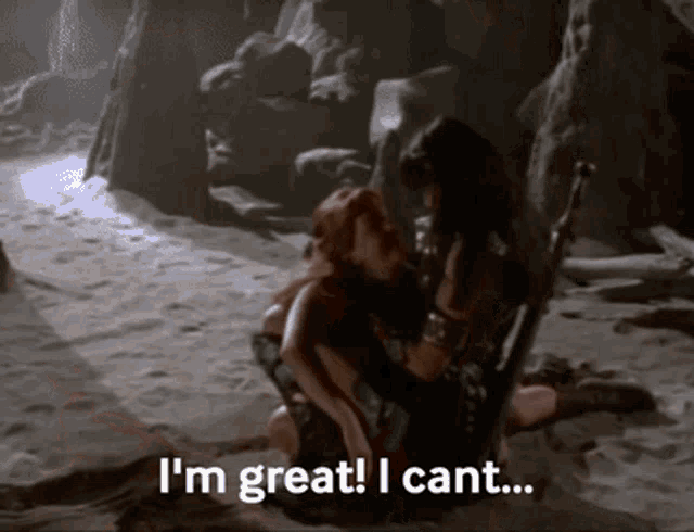 a man and a woman are sitting in the sand and the man says " i 'm great ! i cant ... "