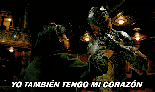 a woman is hugging a monster and the words yo tambien tengo mi corazon are visible