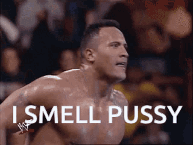 a shirtless wrestler with the words i smell pussy written on his chest