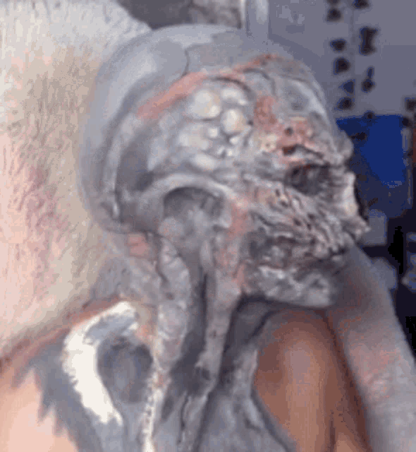 a close up of a person 's face painted like a zombie