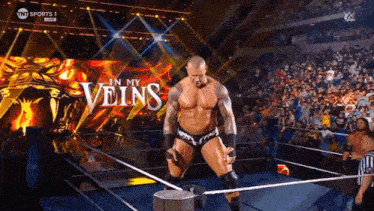 a man in a wrestling ring with the words " in my veins " behind him