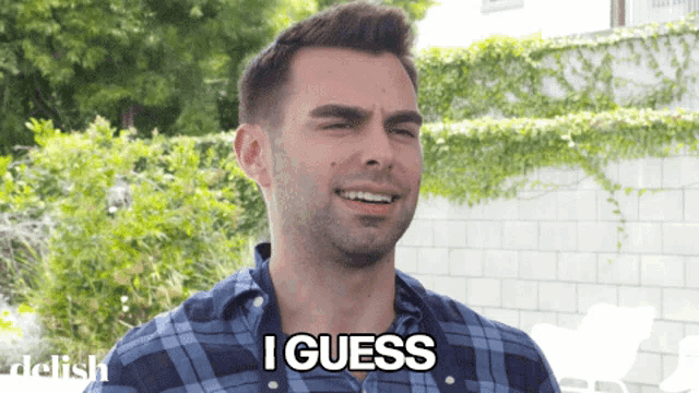 a man in a plaid shirt is smiling and says i guess