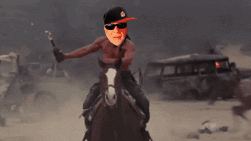 a man is riding a horse in the desert and holding a stick in his hand