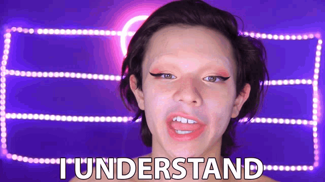 a woman with makeup on her face says " i understand " in front of purple lights