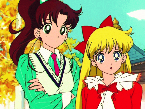 a couple of anime girls standing next to each other with their arms crossed