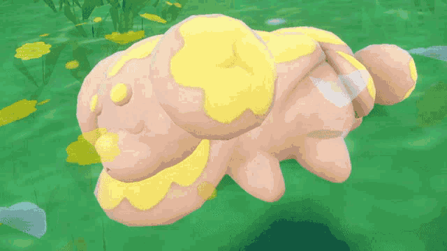 a stuffed animal with yellow spots on it laying on the grass