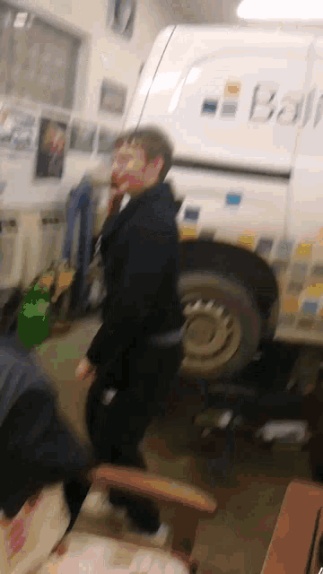 a man standing in front of a white van with the word box on the side