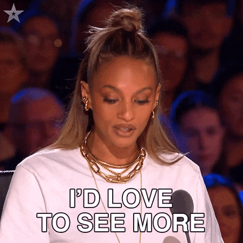 a woman says i 'd love to see more while standing in front of a crowd