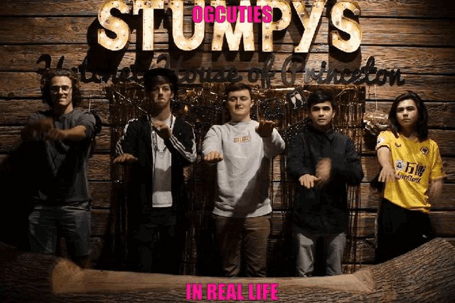 a group of young men standing in front of a sign that says stumpys