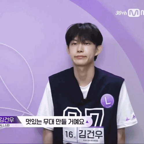 a man wearing a black vest and a white shirt has the number 16 on his shirt