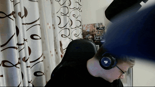 a man wearing headphones with the letter g on the front