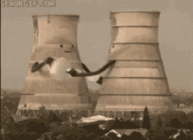 a nuclear power plant is being demolished and smoke is coming out of it .