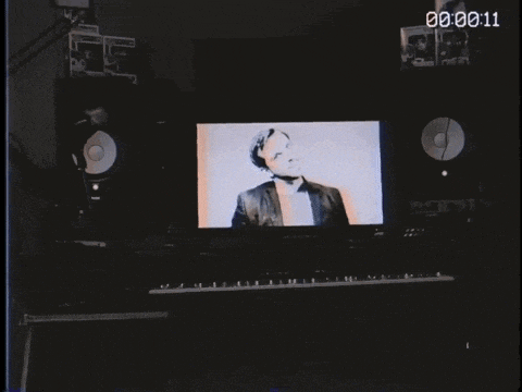 a black and white video of a man 's face is being played on a computer monitor
