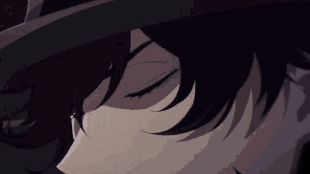a close up of a person 's face with a hat on