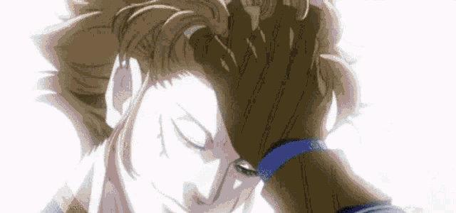 a close up of a person holding another person 's hand to their head .