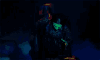 a person is sitting at a desk in a dark room with a blue light behind them