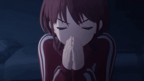 a girl with her eyes closed and her hands folded