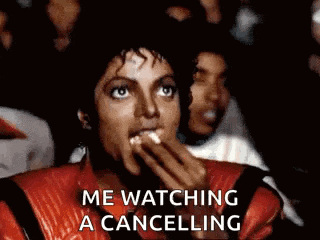 michael jackson is eating popcorn while watching thriller in a theater .