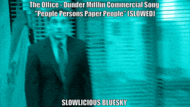 a blurred image of a man in a suit and tie with slowlicious bluesky written below him