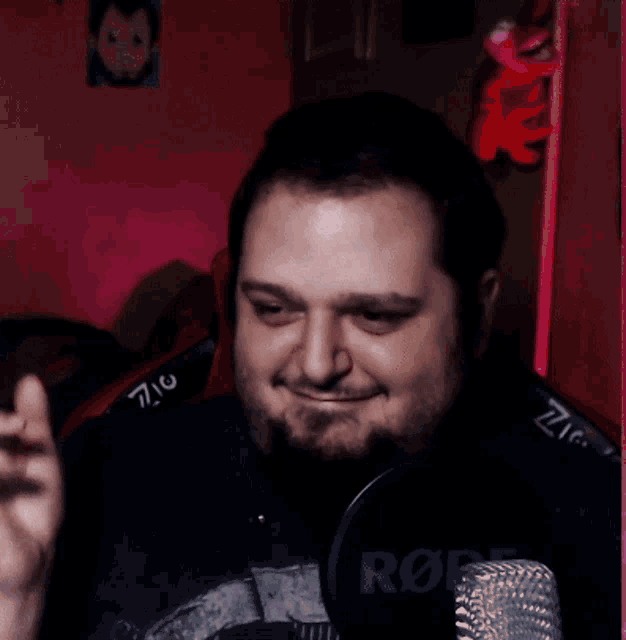 a man wearing a black shirt with the word rode on the front