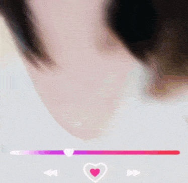 a close up of a person 's face with a pink heart in the middle