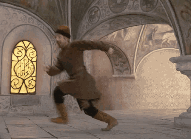 a man in a brown coat is running in front of a stained glass window with the letter s on it