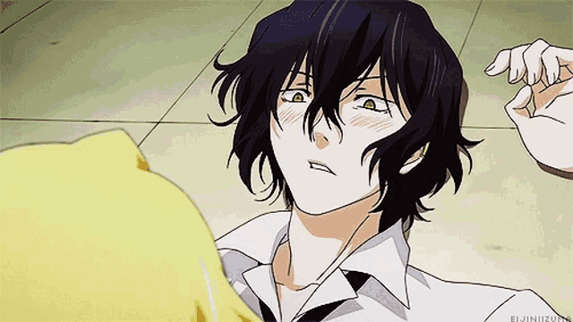 a man with long black hair is being touched by another person 's hand .