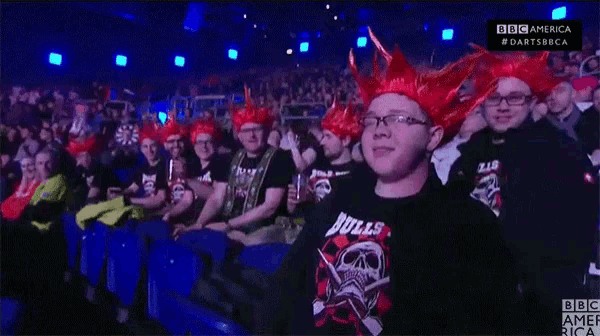a man wearing a bulls shirt sits in a crowd of people