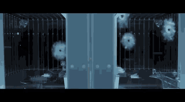 a room with bullet holes in the walls and ceiling
