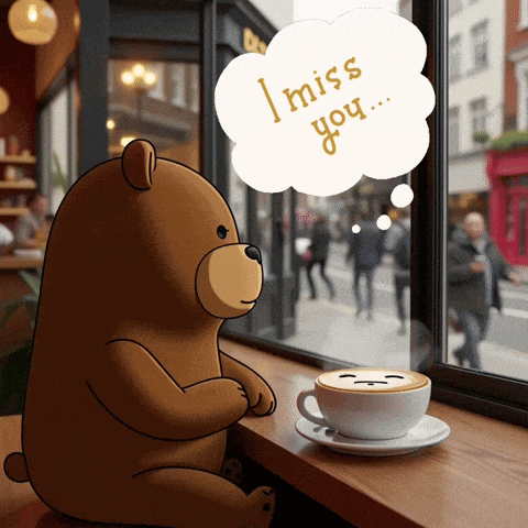 a teddy bear is sitting at a table with a cup of coffee and a speech bubble that says i miss you