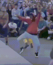 a man in a red jacket is dancing in front of a crowd of people