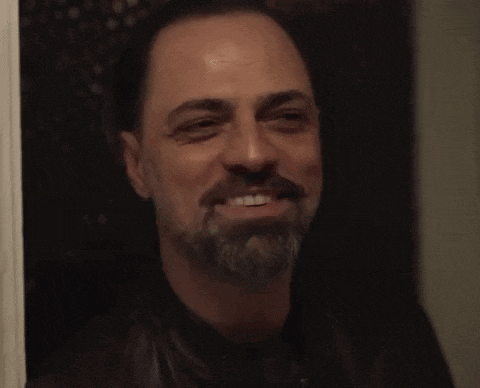 a man with a beard and a wedding ring on his finger