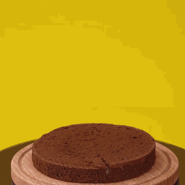 a chocolate cake is being decorated with frosting and the word easy is on the bottom