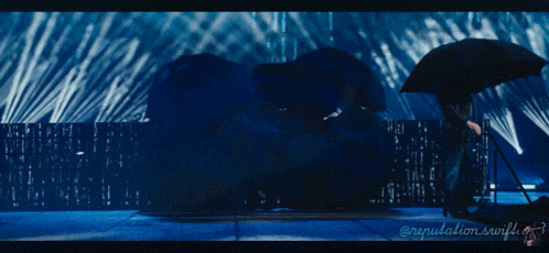 a person holding an umbrella in front of a blue background with the words " reputation.swift.gf " on the bottom