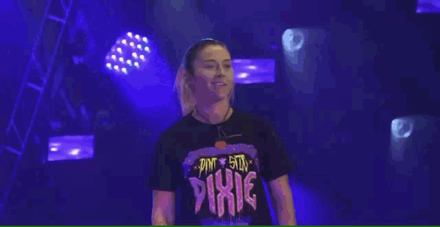a woman wearing a black shirt with the word pixie on it