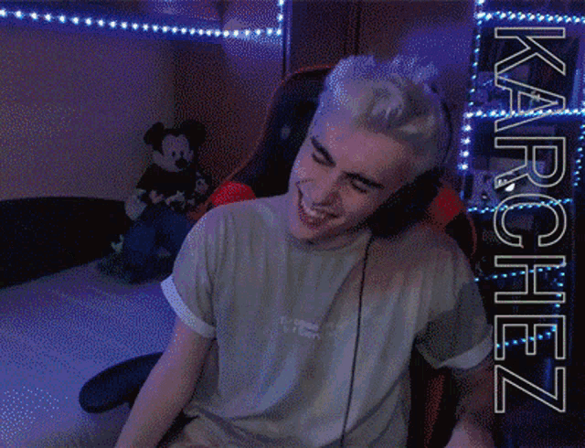 a man wearing headphones and a shirt that says karchez