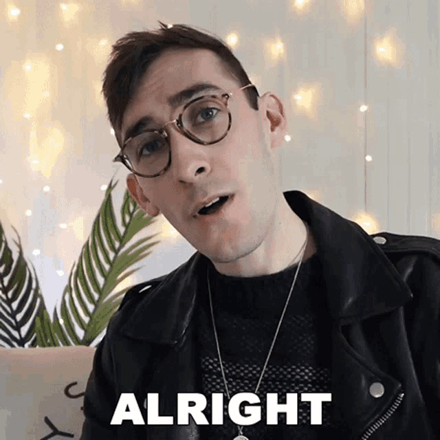 a man wearing glasses and a leather jacket has the word alright on his face
