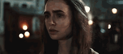 a close up of a woman 's face in a dark room