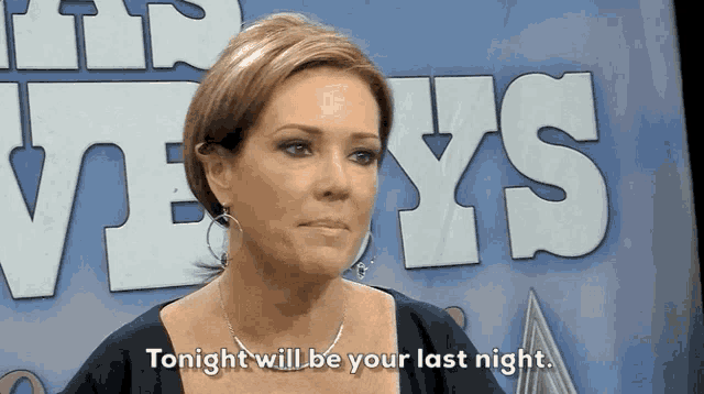 a woman says tonight will be your last night in front of a sign