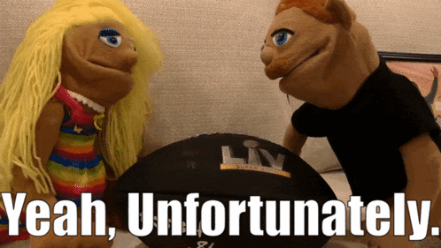 a couple of stuffed animals standing next to a football that says liv on it